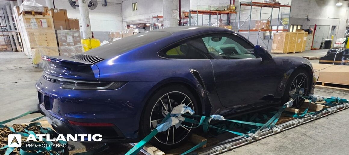 Blue Porsche 911 being prepared for shipping