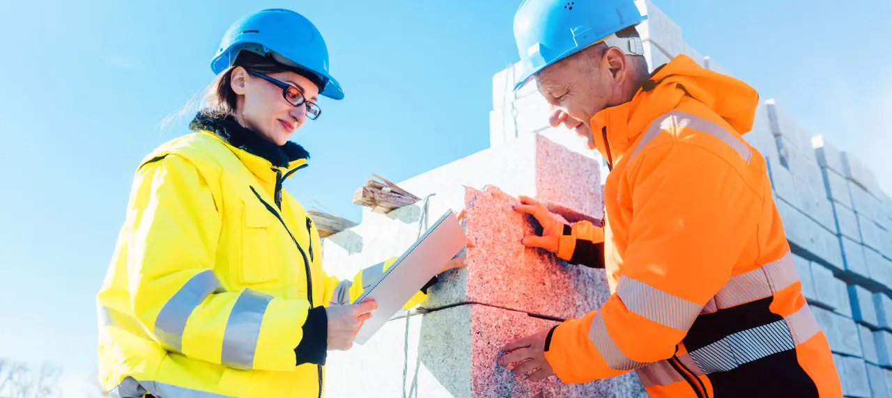 Construction managers checking plan and delivered materials